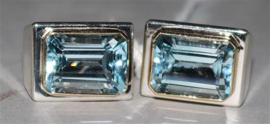 A pair of silver and blue topaz ear clips.